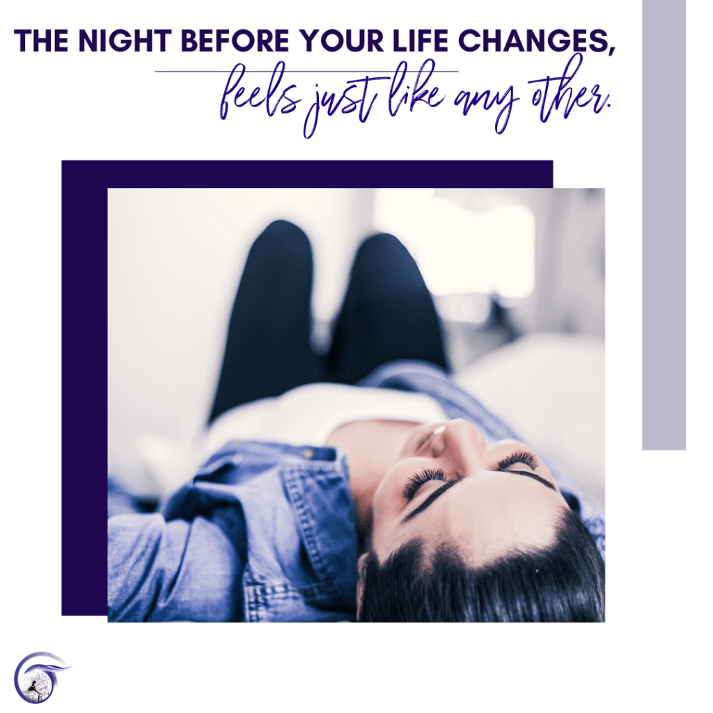 A picture of a woman lying on a bad, head facing up, smiling as she relaxes after a long day.